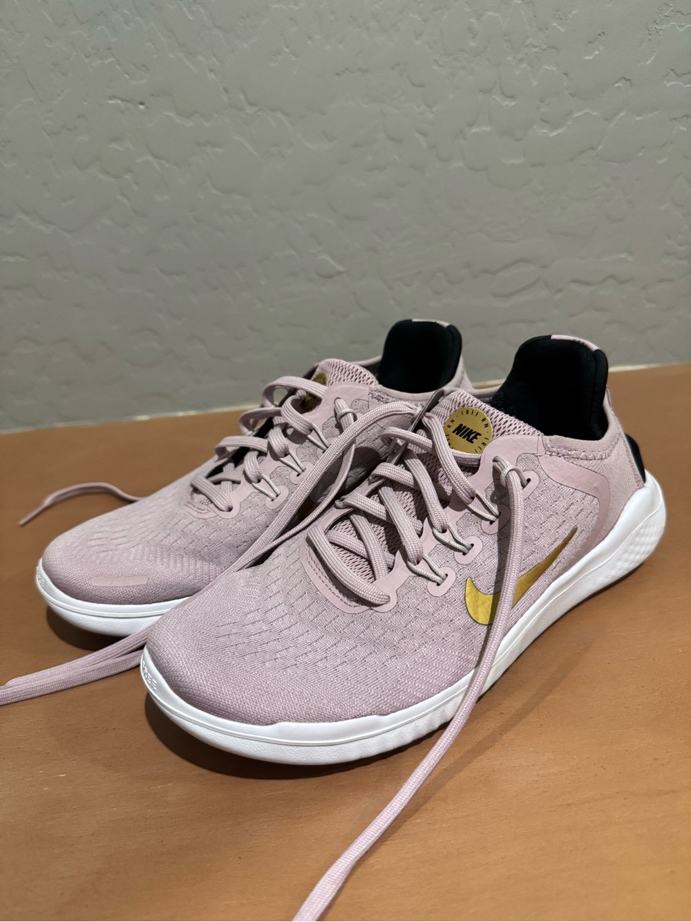 Nike Women's Light Pink Athletic Sneakers with Gold Swoosh